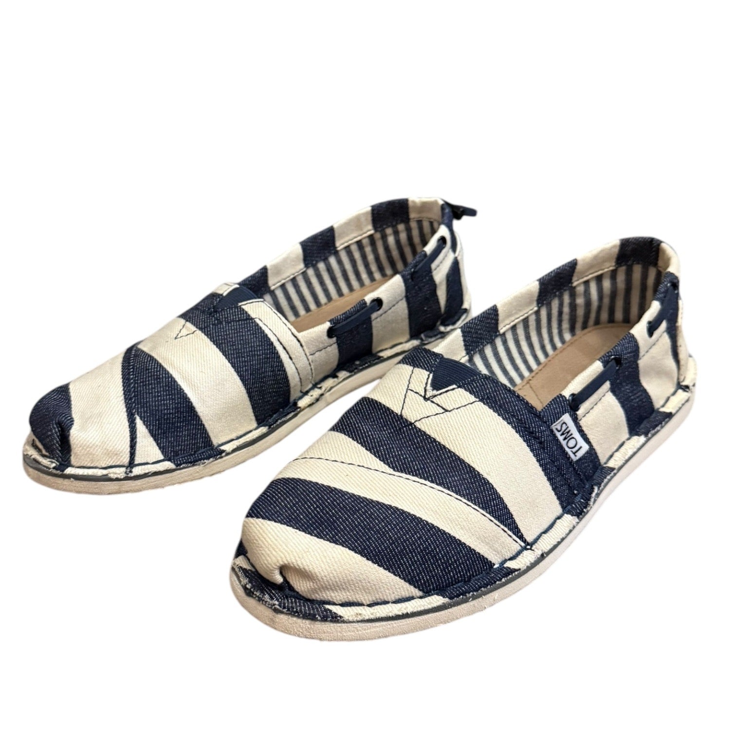 Navy and white striped shoes on a white background