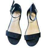 Pair of black sandals with a brand logo on a white background