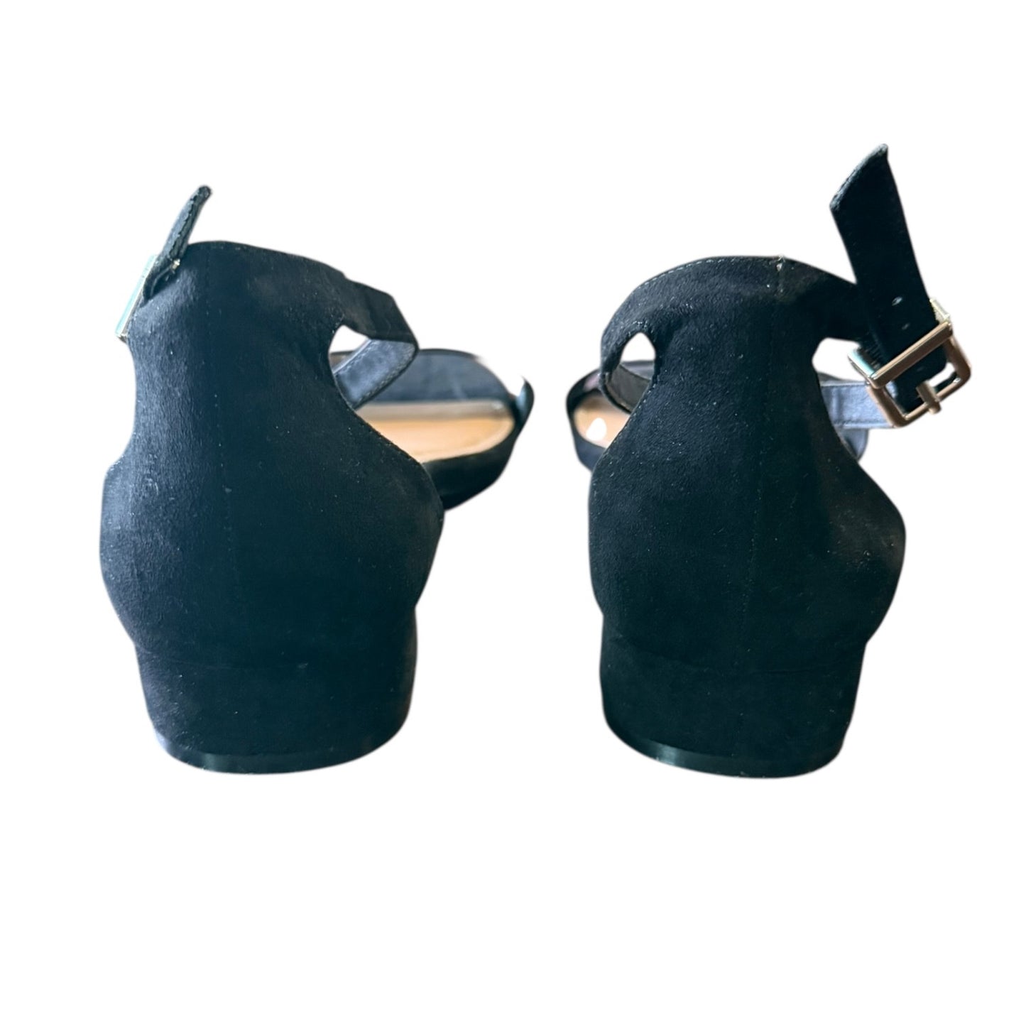 Back of black shoes with a strap on a white background