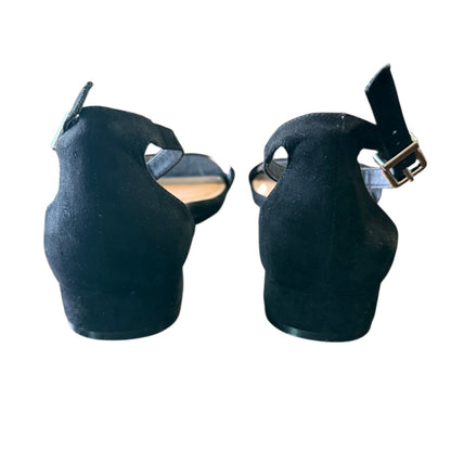 Back of black shoes with a strap on a white background