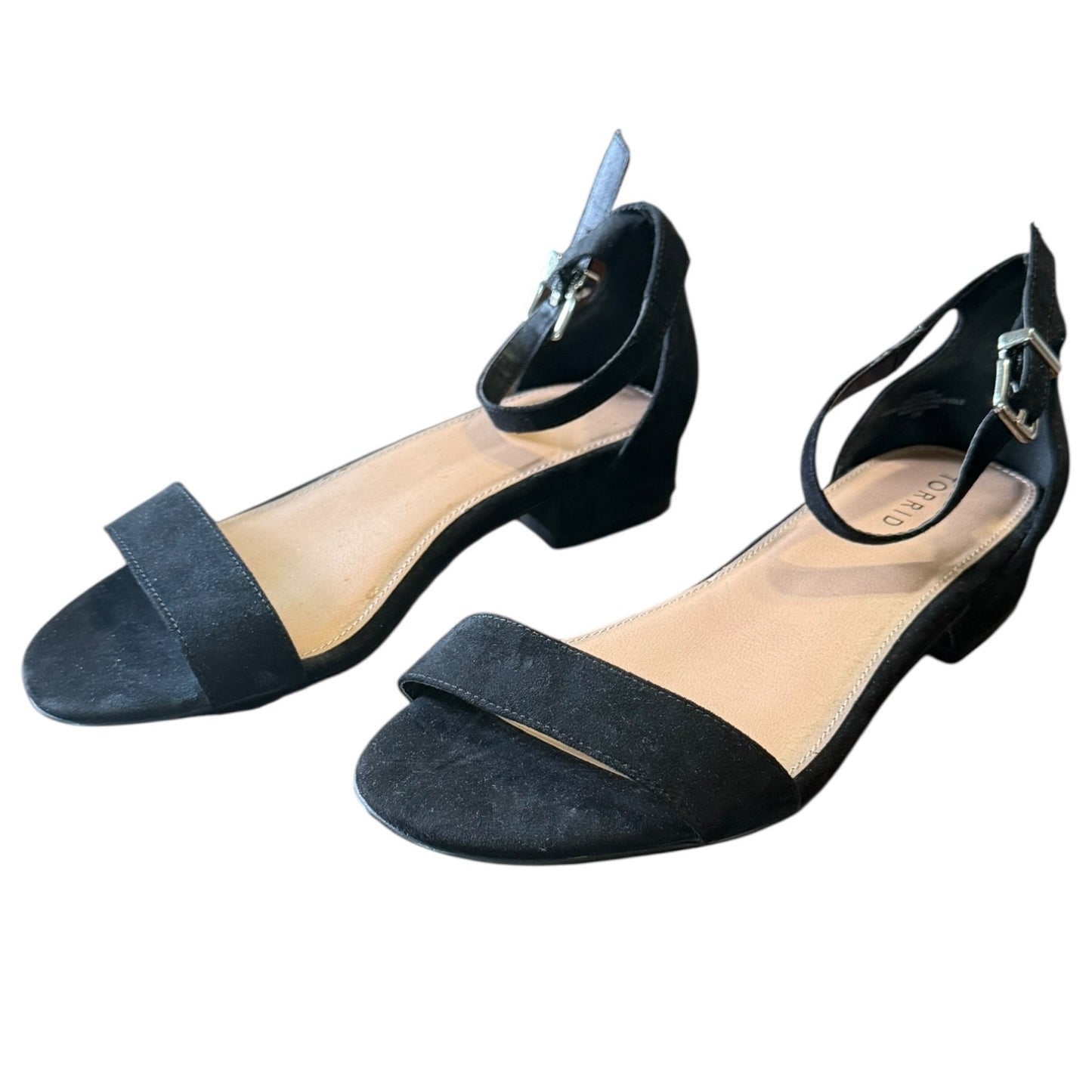 Pair of black open-toe shoes with straps on a white background