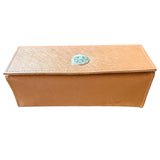 Bottom of orange case with a decorative emblem on a white background