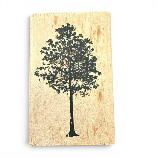 Silhouette of a tree on a textured beige block background