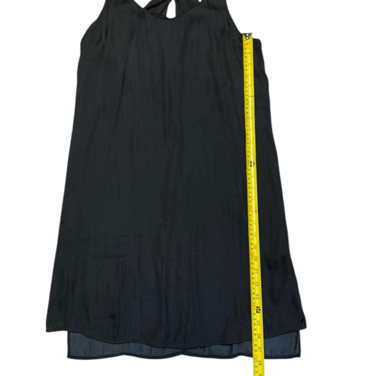 Black dress with a yellow measuring tape on a white background