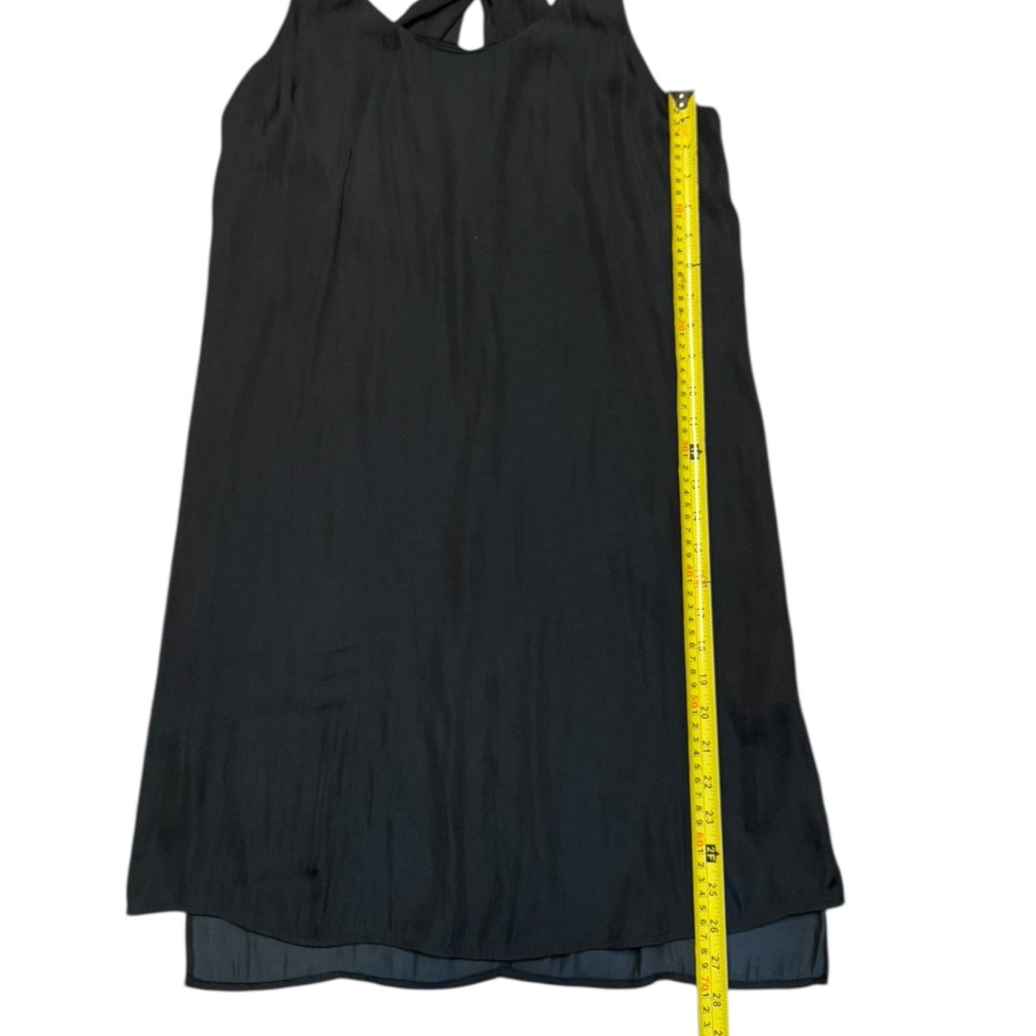 Black dress with a yellow measuring tape on a white background