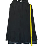 Black dress with a yellow measuring tape on a white background