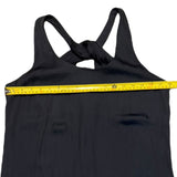 Black tank dress with a yellow measuring tape across it on a white background