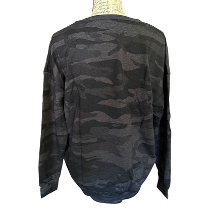 Back of camouflage long-sleeve sweater on a mannequin with a white background