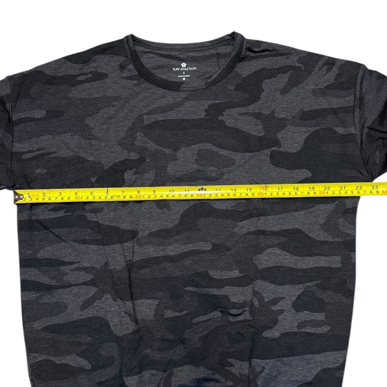 Camouflage sweater with a measuring tape across it, displayed on a white background.