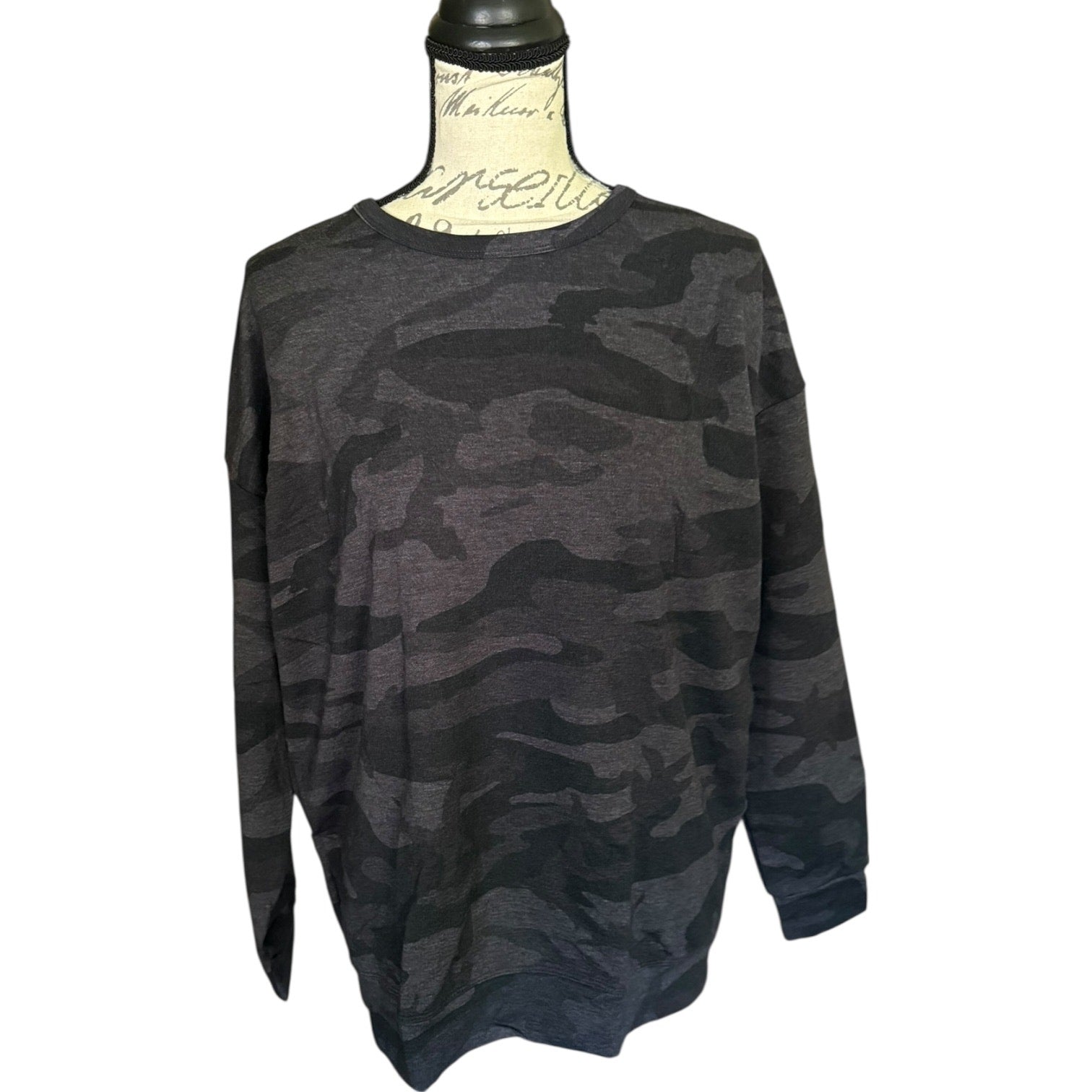 Front of Camouflage-patterned sweater on a mannequin against a white background