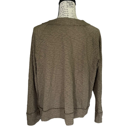 Back of green sweater on a mannequin with a white background