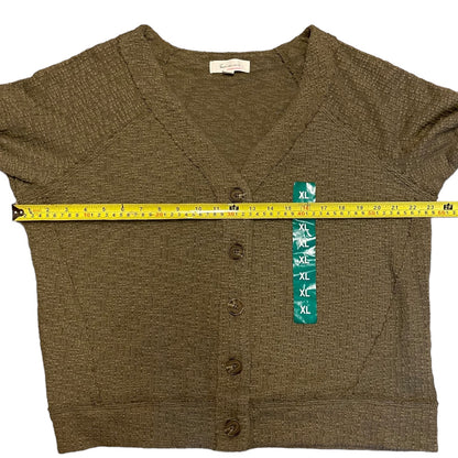 Green cardigan with a measuring tape and size tag on a white background