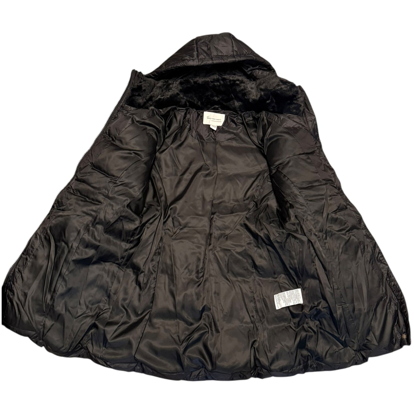 A black quilted puffer jacket with a plush black faux-fur hood lining, laid flat against a white background. Two small white brand labels are visible on the interior.