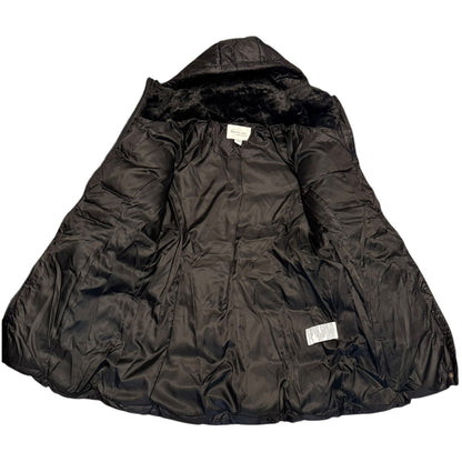 A black quilted puffer jacket with a plush black faux-fur hood lining, laid flat against a white background. Two small white brand labels are visible on the interior.