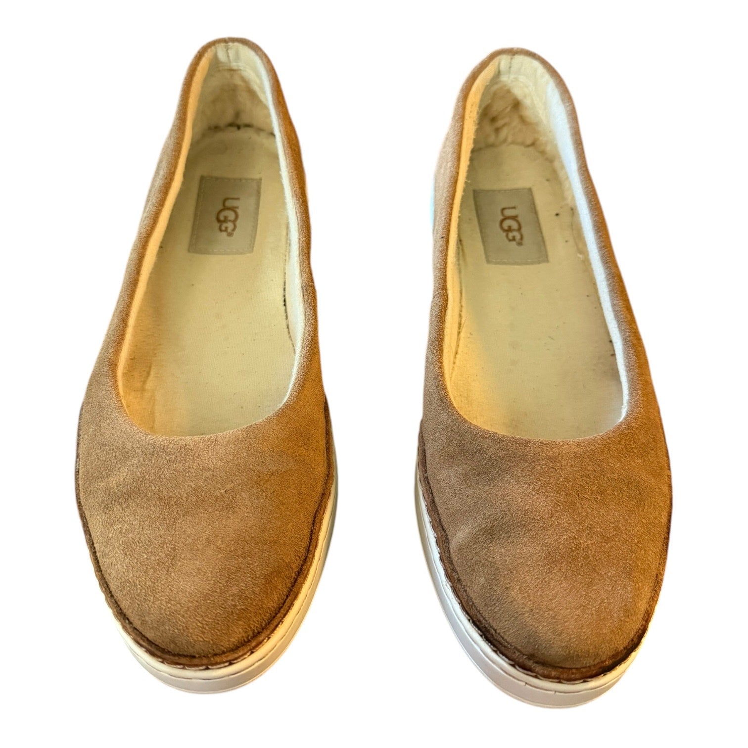 Front of brown suede shoes with UGG label on a white background