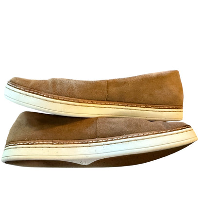 Side of brown suede shoes with white soles on a white background
