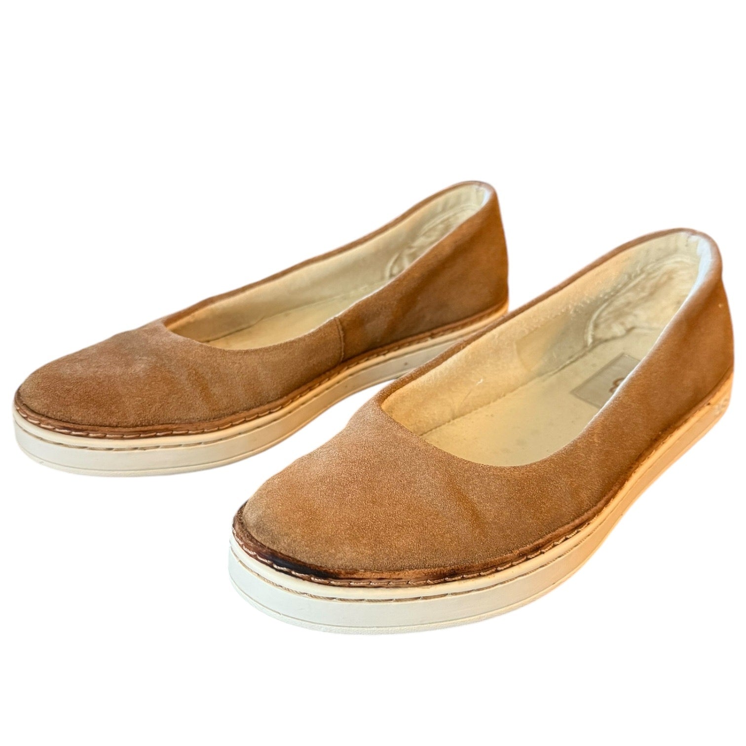 Pair of brown flat shoes on a white background front side