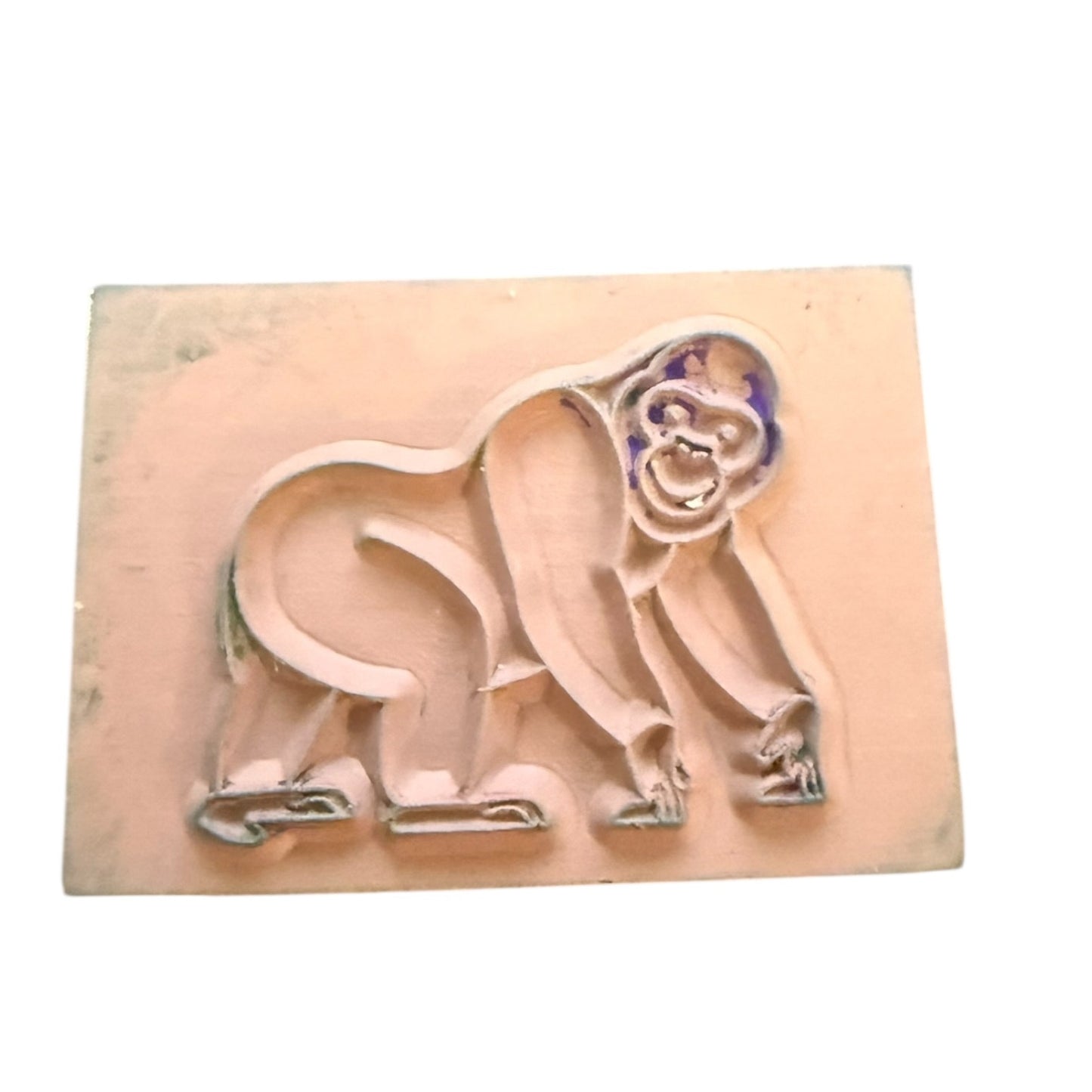 Gorilla stamp with ink marks on a wooden block