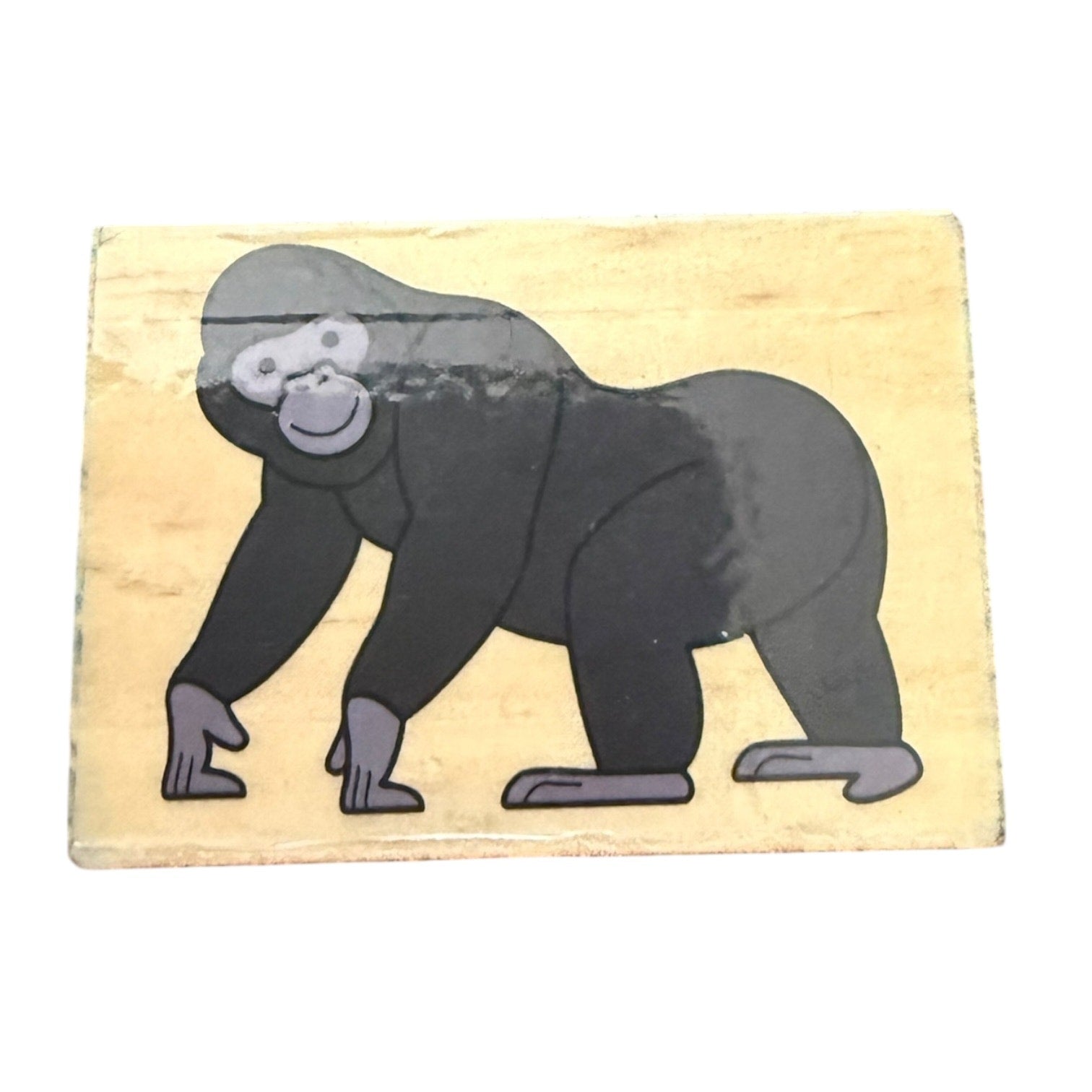 Rubber stamp with a gorilla design on a wooden block