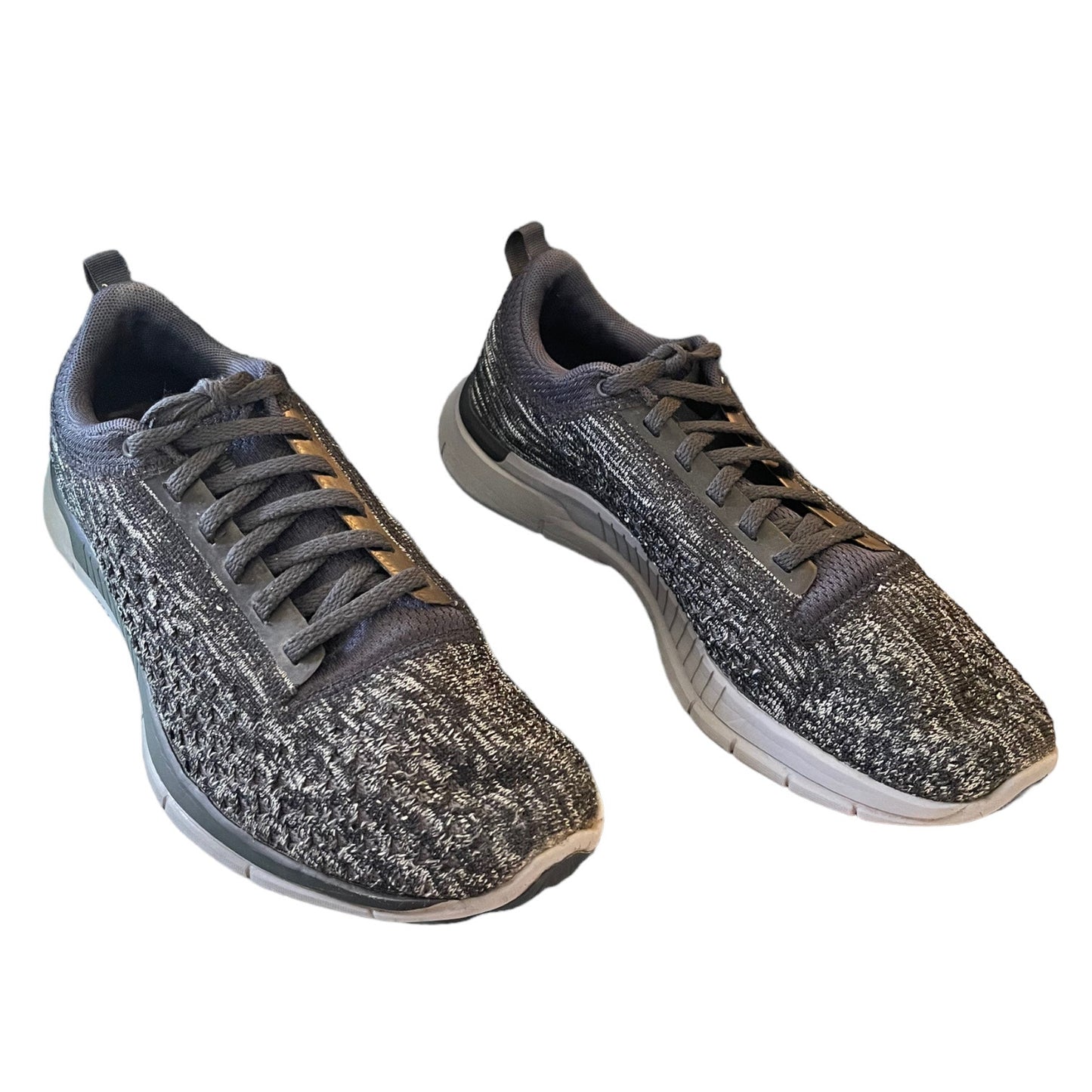 Front side of gray and black athletic shoes on a white background