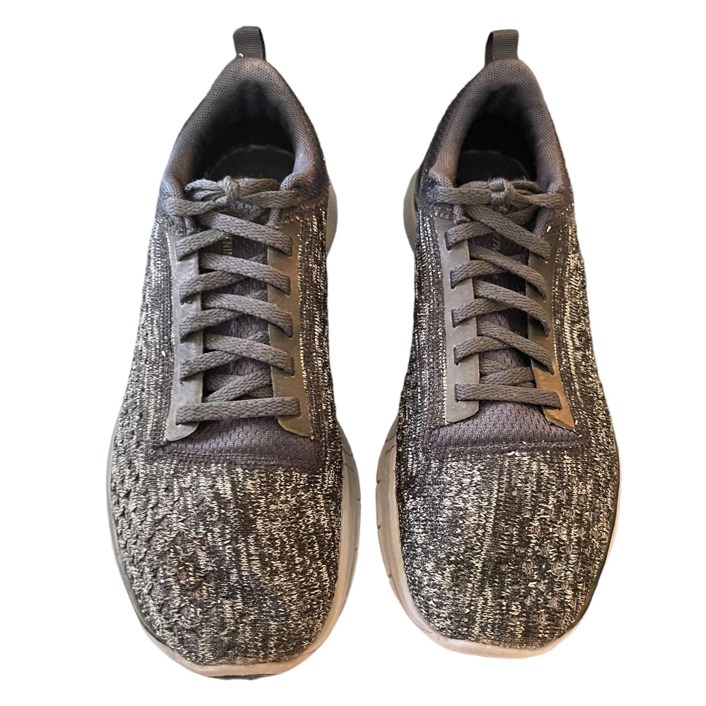Front of a Pair of gray sneakers on a white background