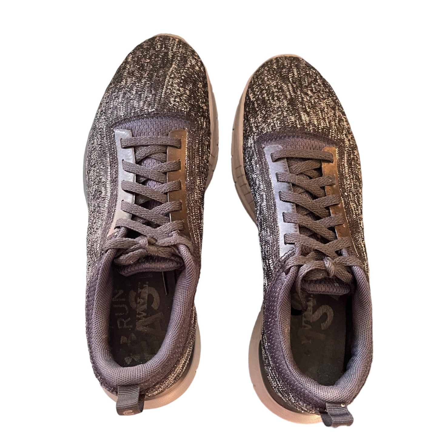 Top of gray sneakers with textured surface on a white background