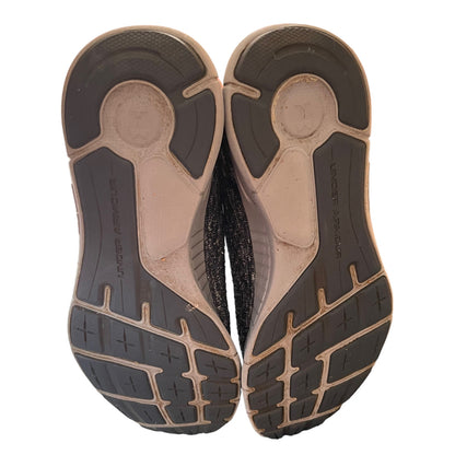 Bottoms of gray running shoe soles on a white background