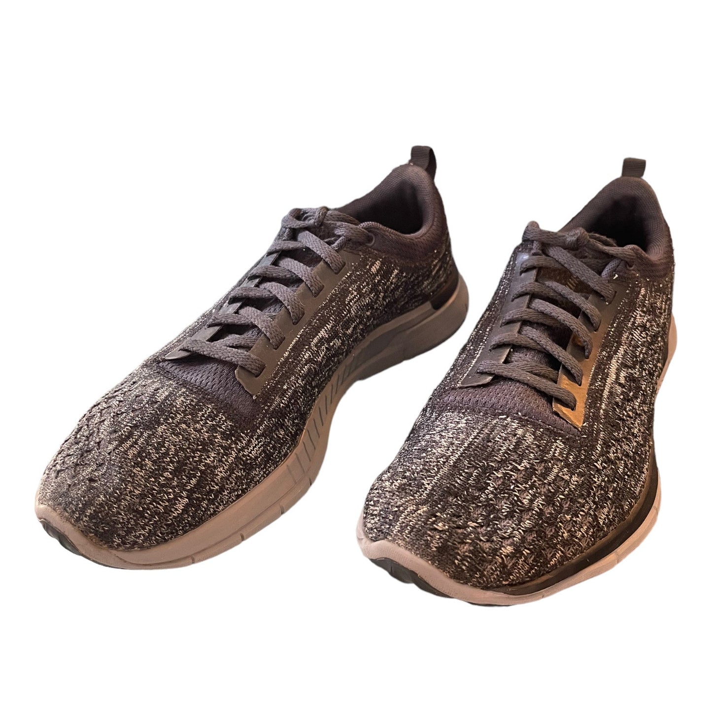 Front side of gray sneakers on a white background