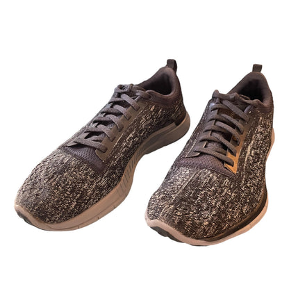 Front side of gray sneakers on a white background