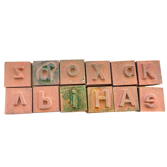 Alphabet blocks with rubber letters on a white background
