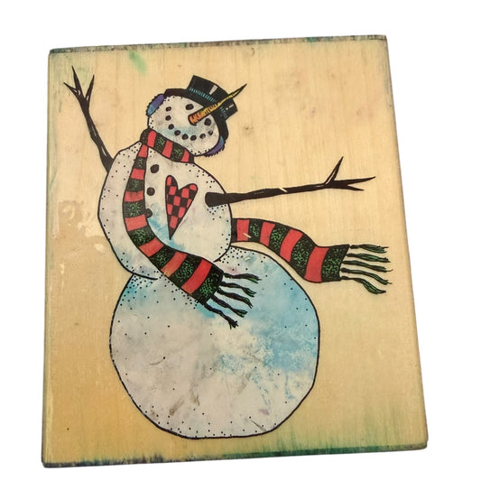 Wooden block with a snowman design on a light background