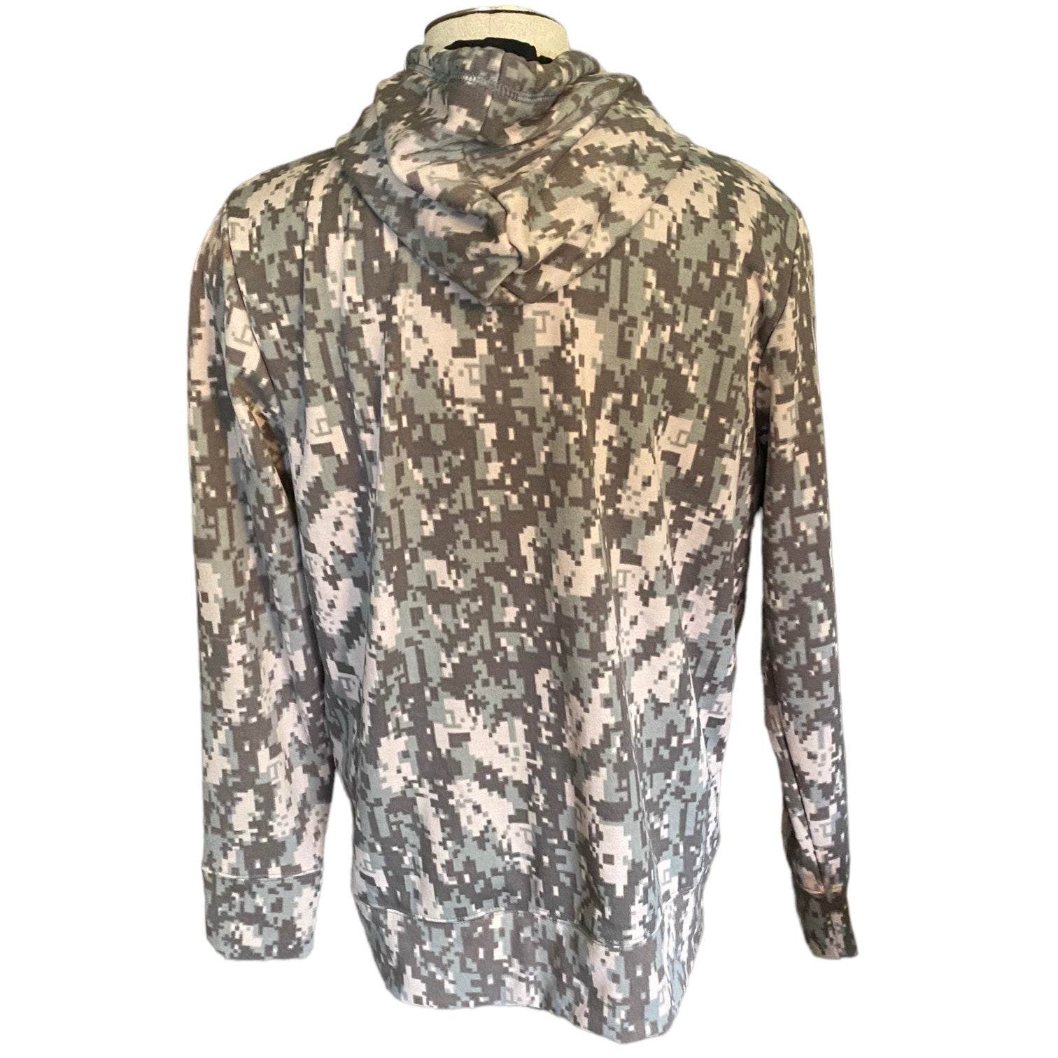 A long-sleeve hooded jacket with a digital camouflage pattern , displayed on a mannequin torso against a white background.