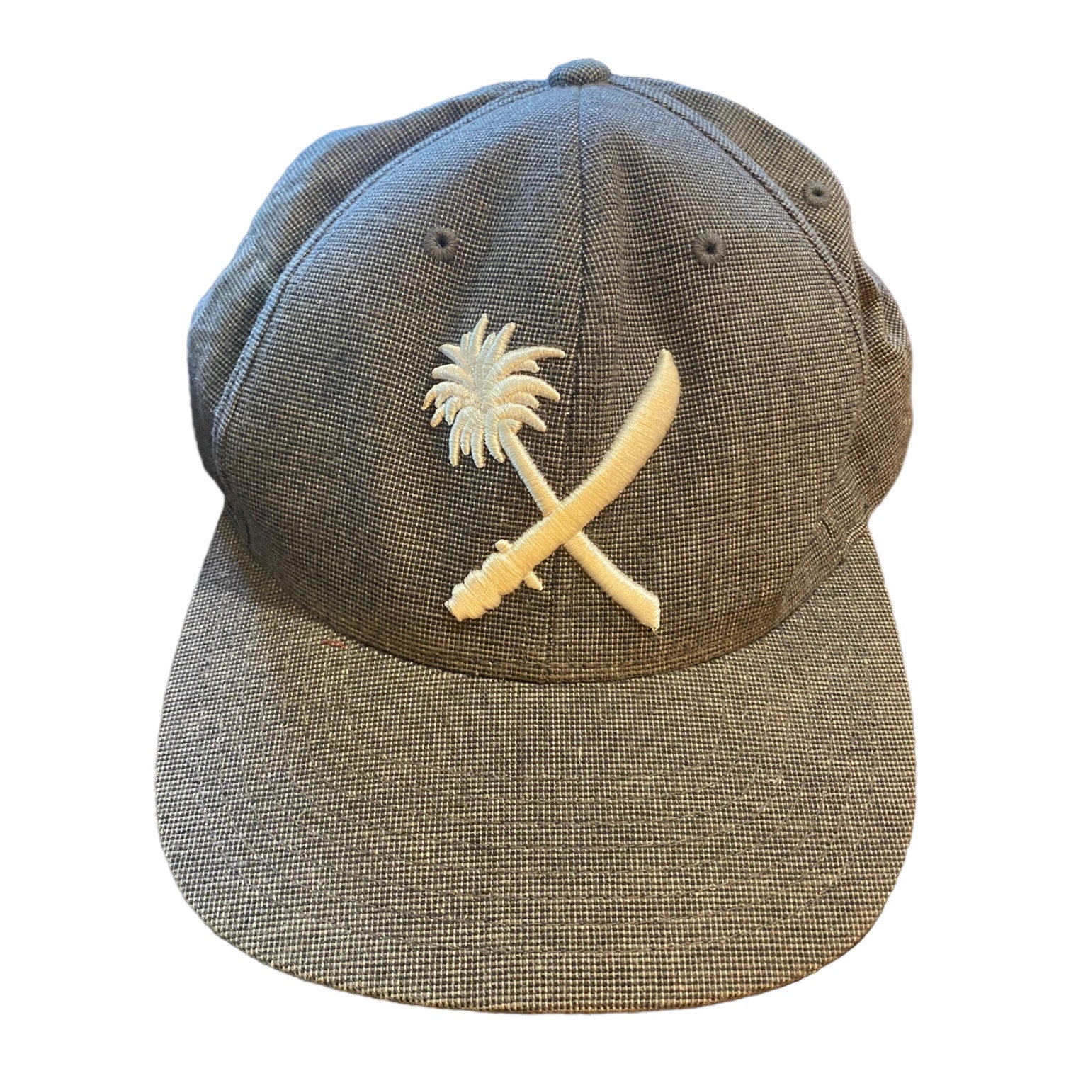 Front of Gray cap with a palm tree and crossbones design on a white background