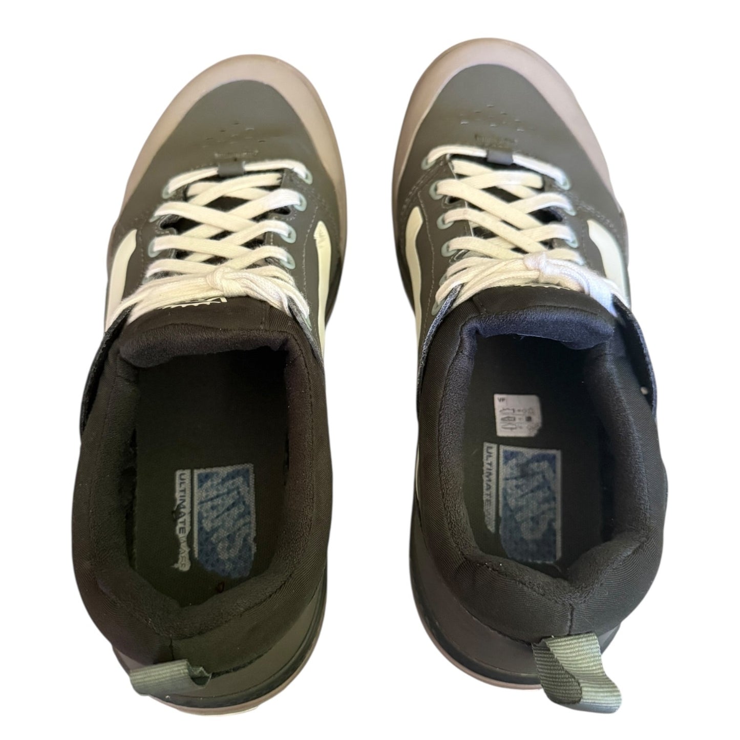 Top of a Pair of green sneakers with white laces on a white background