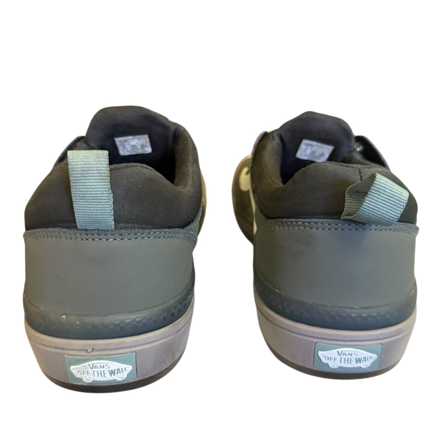 Back of a Pair of green sneakers with visible brand logo on a white background