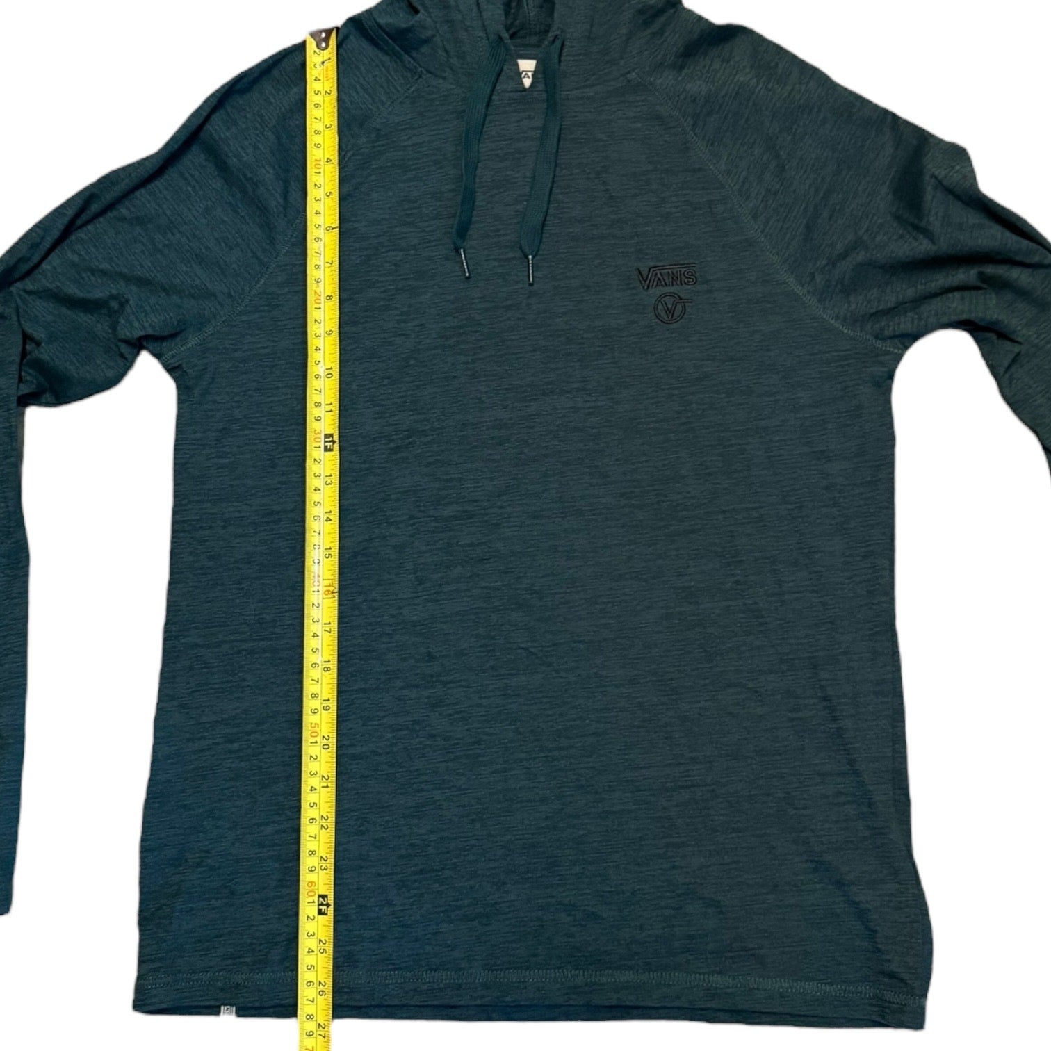 Green hoodie with a measuring tape on a white background