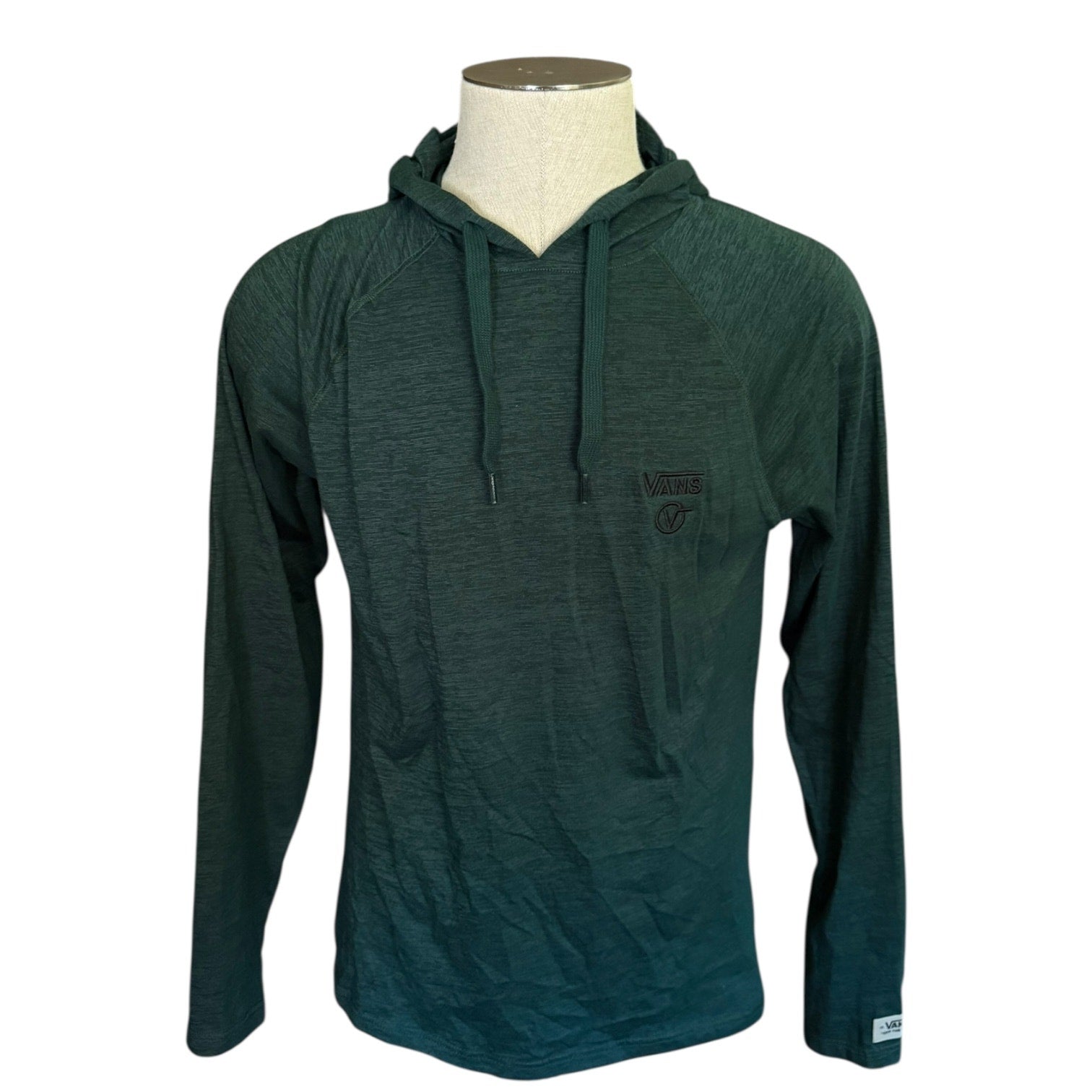 Front of green hoodie on a mannequin against a white background