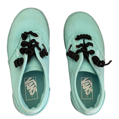 Pair of green Vans sneakers with black laces on a white background