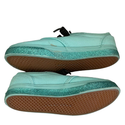 Side view of green sneakers with glittery green sole on a white background