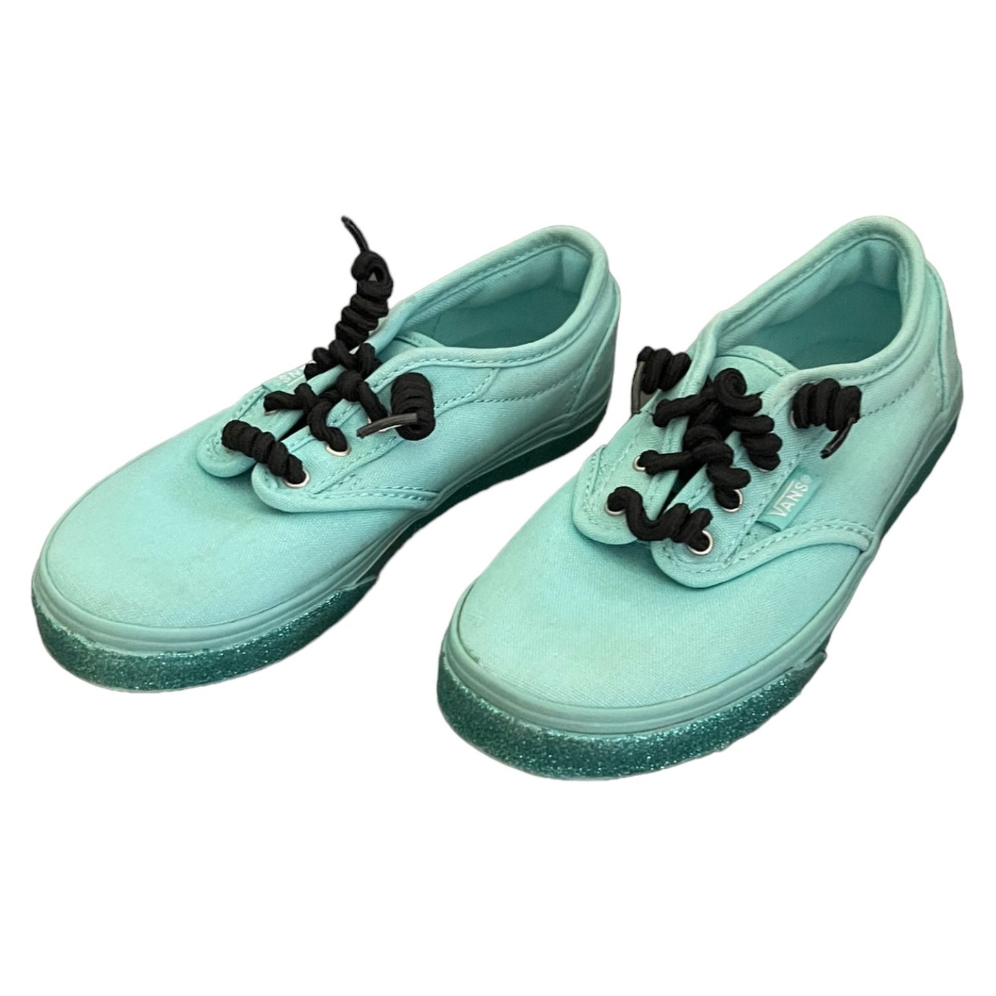 Side view Pair of green sneakers with black laces on a white background