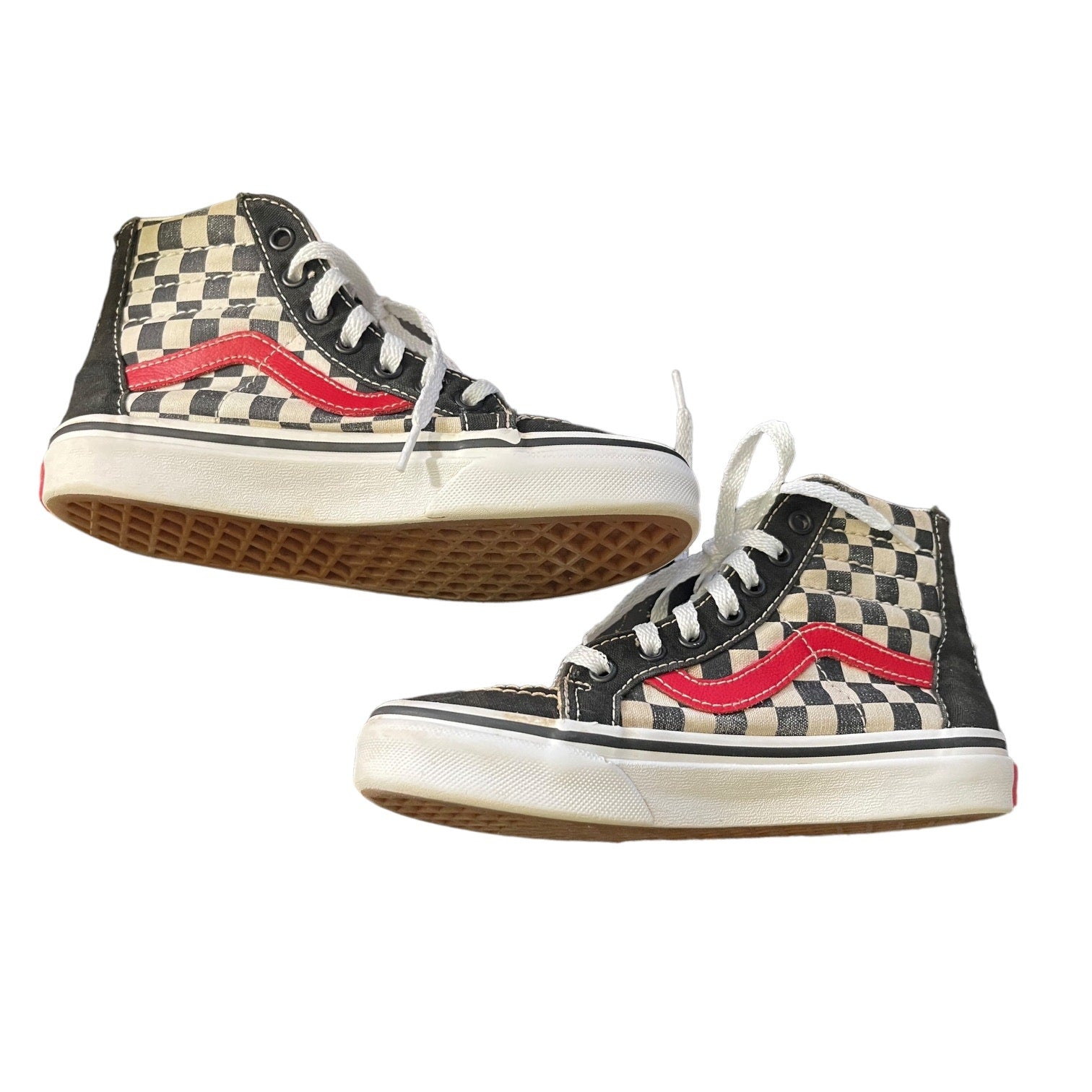 Side view of Pair of checkered high-top sneakers with red accents on a white background