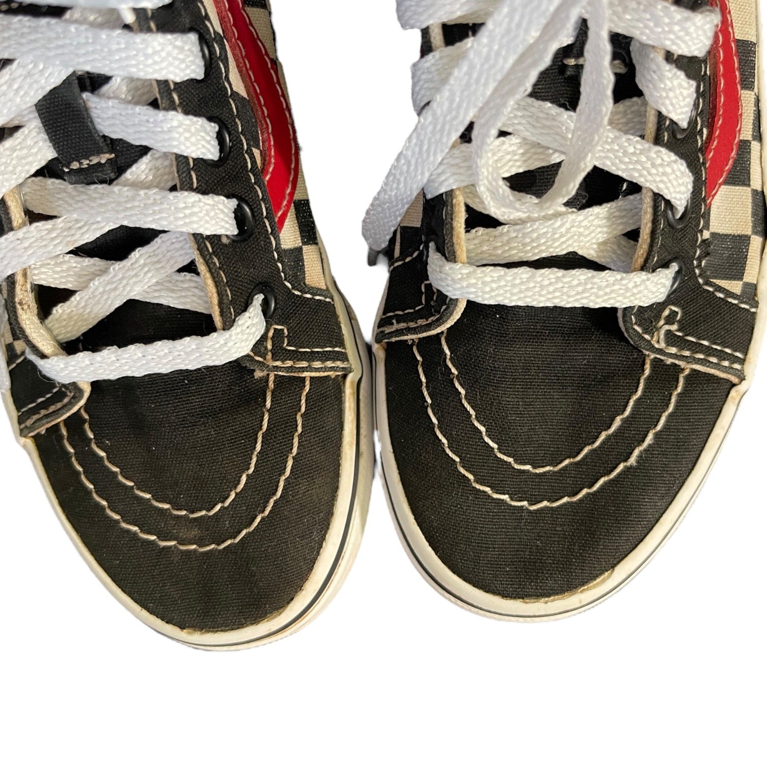 Close up of Black sneakers with white laces on a white background