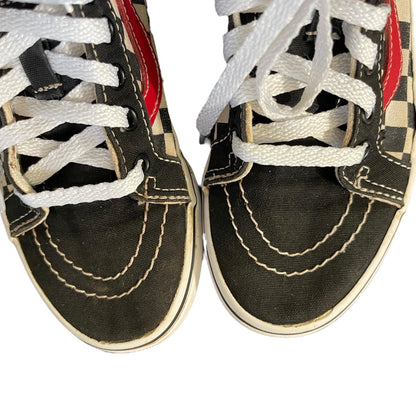 Close up of Black sneakers with white laces on a white background