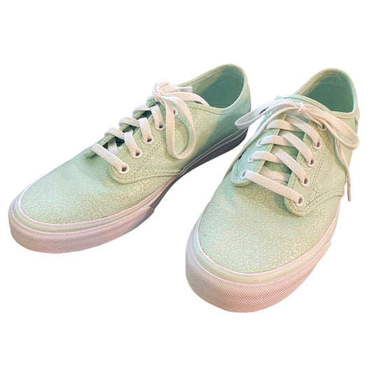 Front side of Pair of light green sneakers with white laces on a white background