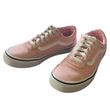 Front side of a Pair of pink sneakers with white laces on a white background