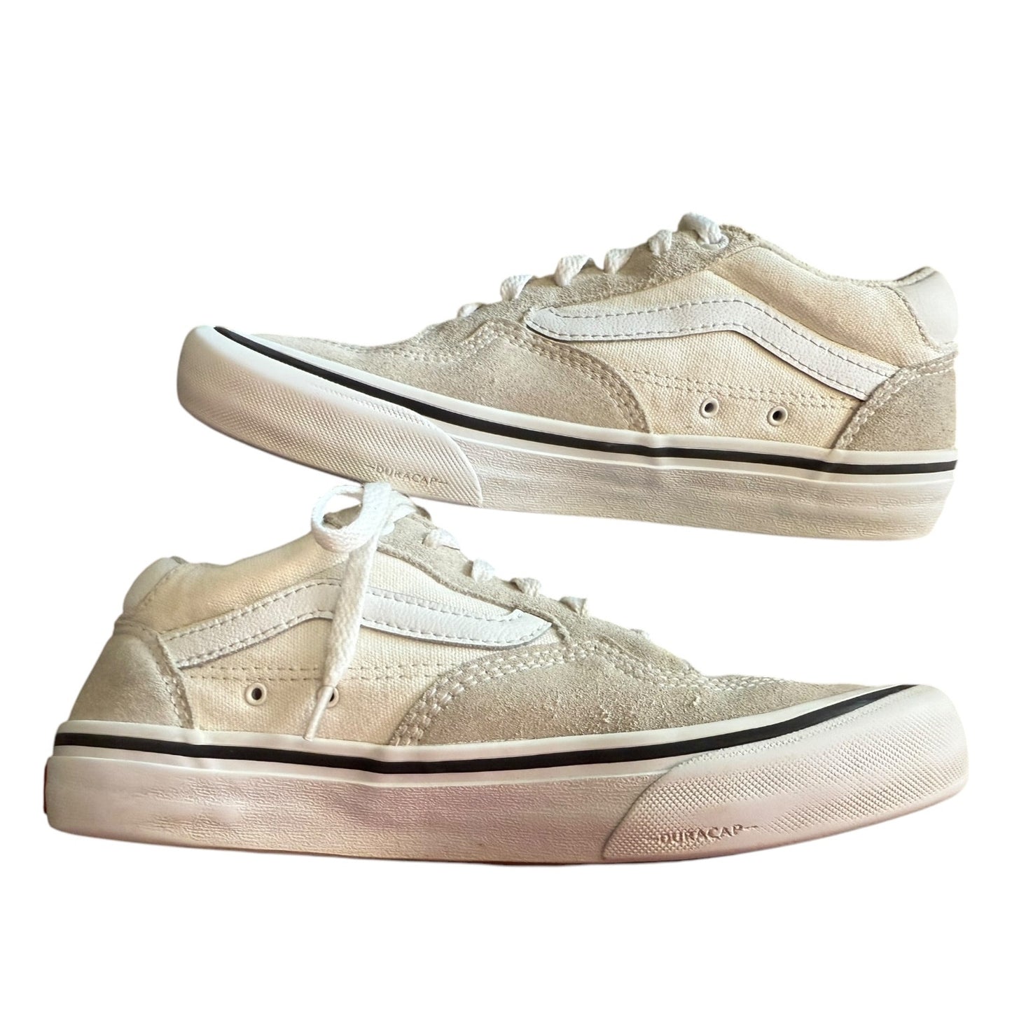 White sneakers on their side with black accents on a white background