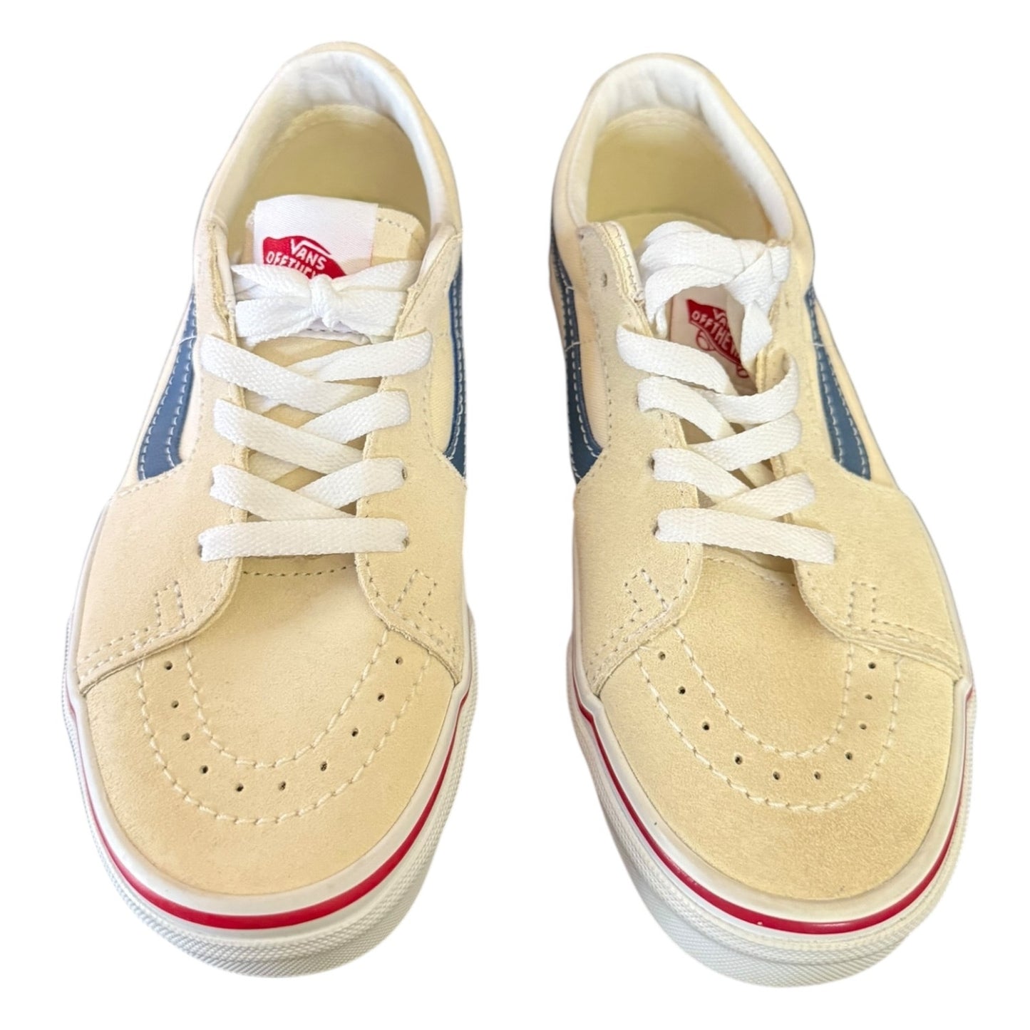 Top of cream sneakers with white laces and pink accents on a white background