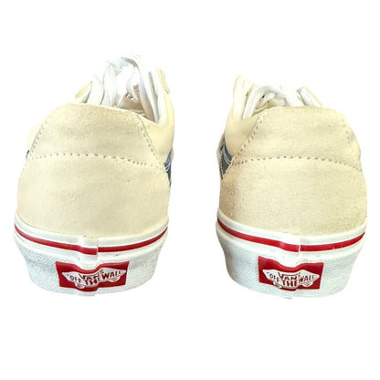 Back of cream sneakers with red and white accents on a white background