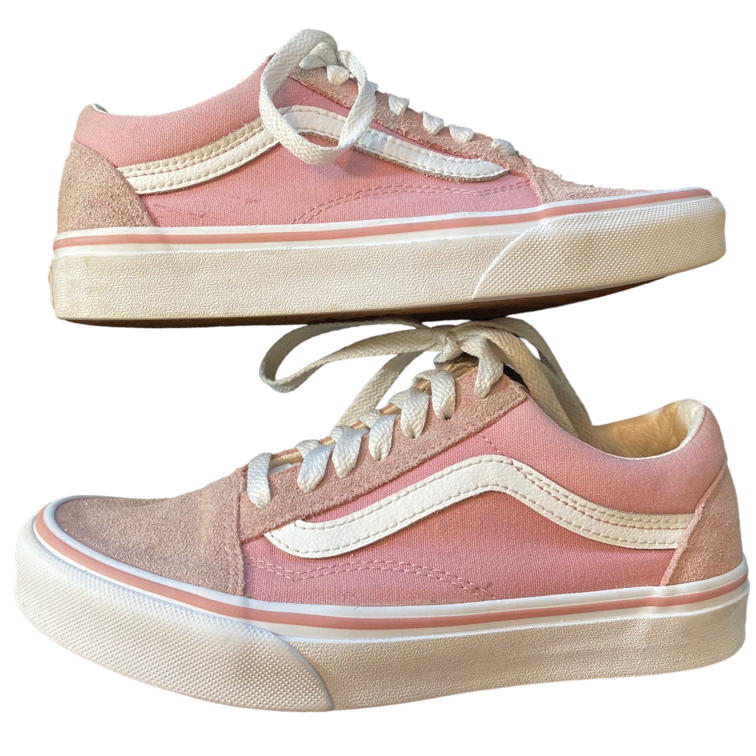 A pair of low-top sneakers in pink suede and canvas, featuring white side stripes, white laces, and a white sole.