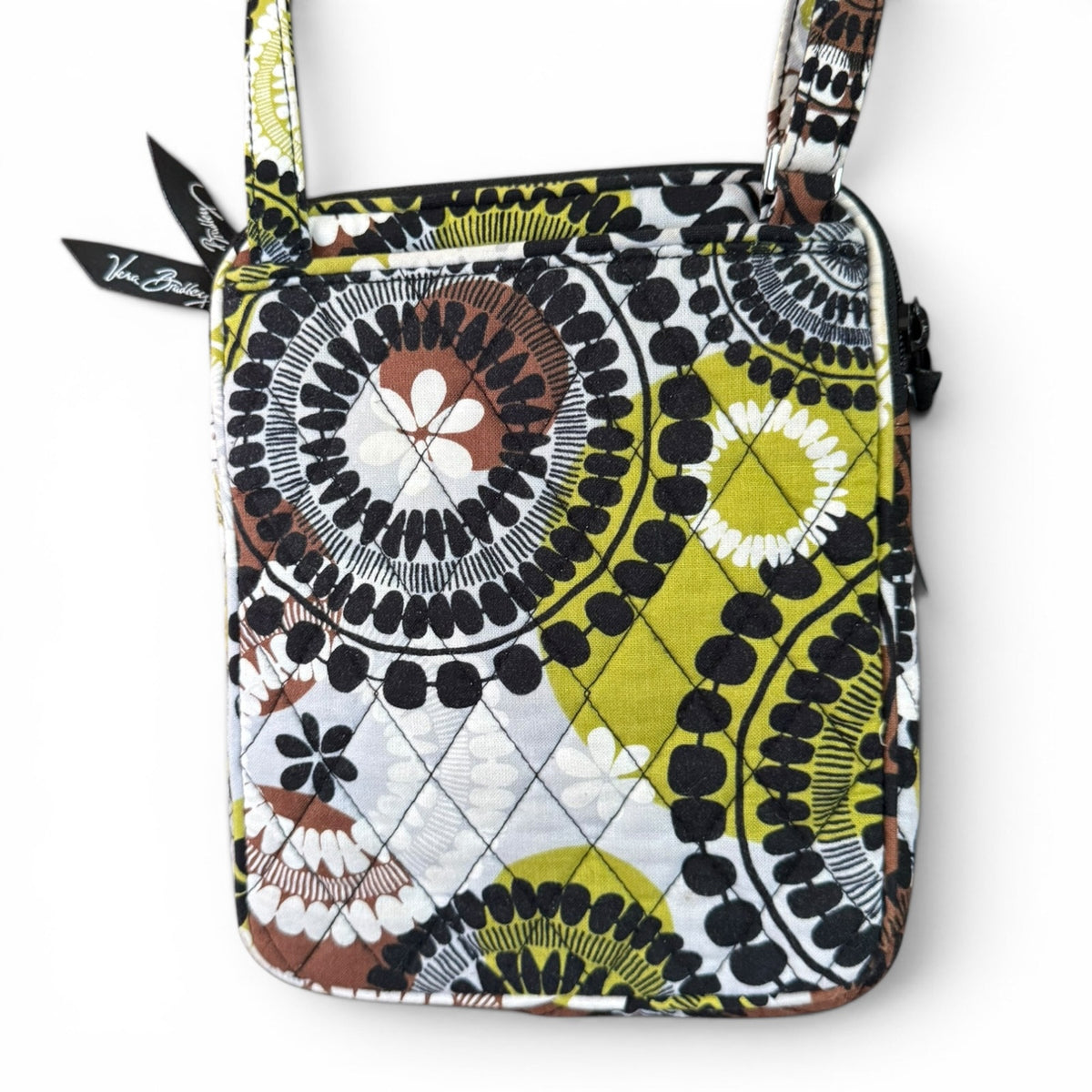 Back of Patterned handbag with a visible brand name on zipper pull on a white background